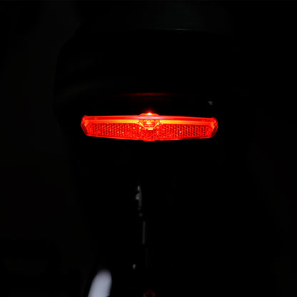 Illuminated red tail light of the Tracer Verge electric fat tire bike, providing enhanced visibility and safety during night rides, by Chico Bikes.